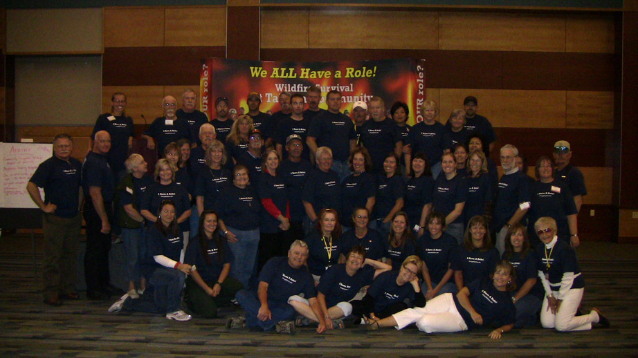 A picture of attendees of a conference posing with matching shirts.