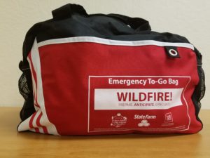 A picture of a duffel bag. That reads, "Emergency To-Go Bag Wildfire! Prepare. Anticipate. Evacuate.